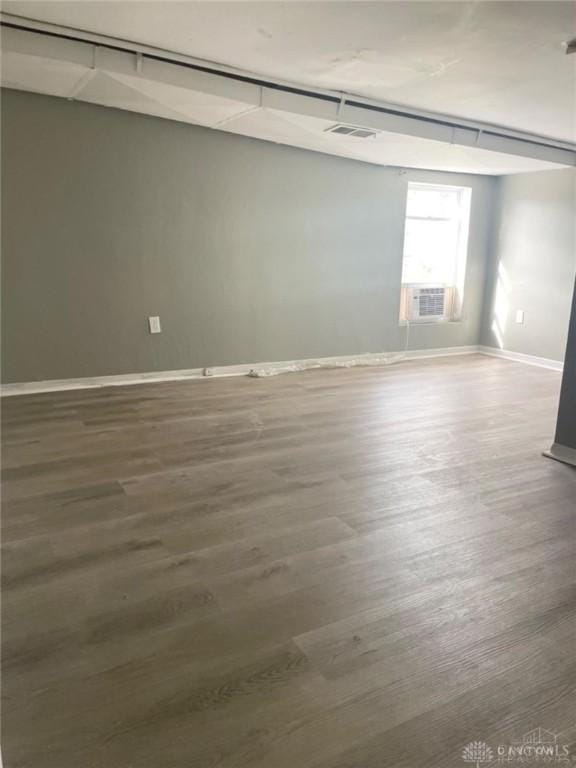 spare room featuring dark wood-type flooring and cooling unit