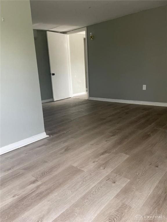 unfurnished room with wood-type flooring