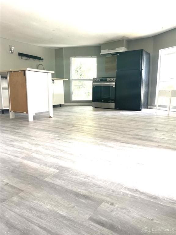 unfurnished living room with light wood-type flooring