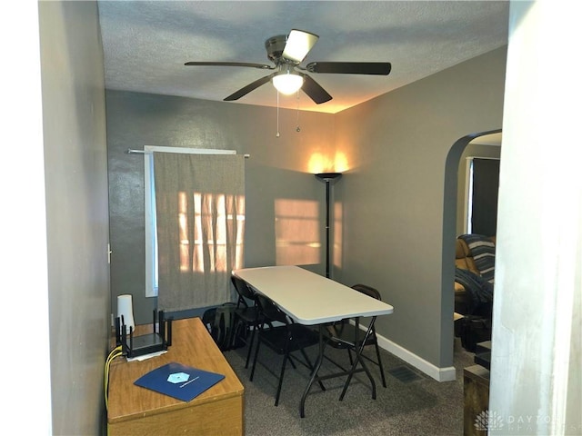 home office featuring carpet flooring, a textured ceiling, and ceiling fan