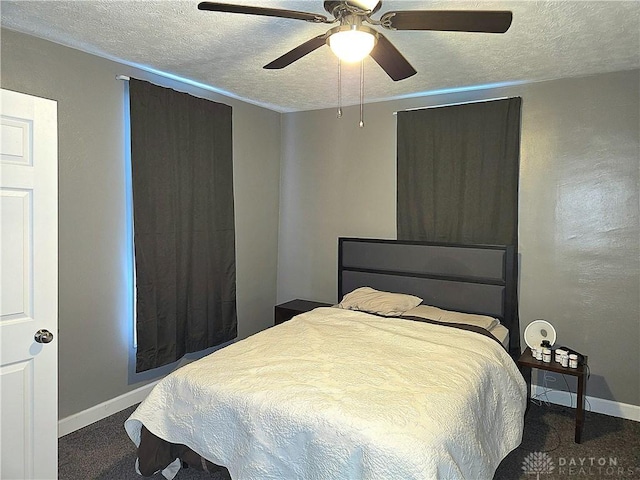 bedroom featuring carpet floors, a textured ceiling, and ceiling fan