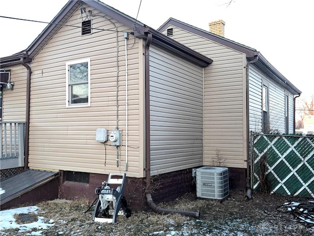 view of side of property featuring central AC