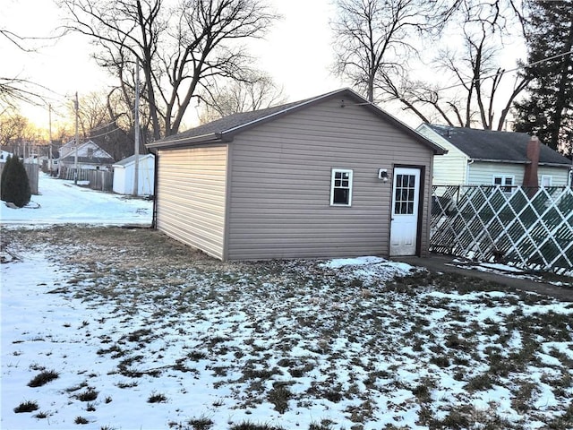 snow covered property with an outdoor structure