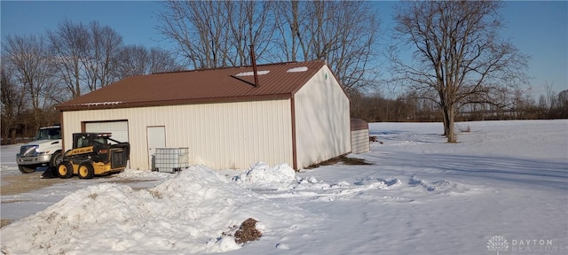 snow covered structure featuring an outdoor structure