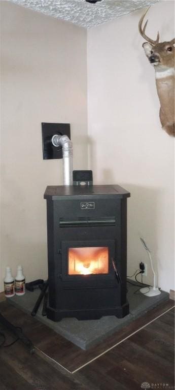 details featuring wood finished floors and a wood stove