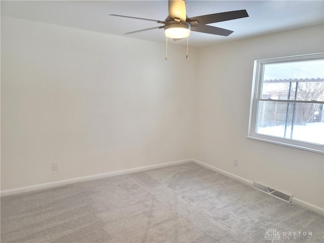 empty room with light colored carpet and ceiling fan