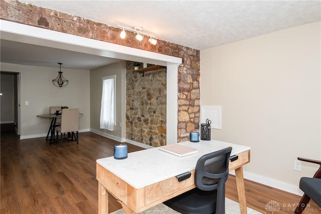 office featuring dark wood-type flooring and a textured ceiling