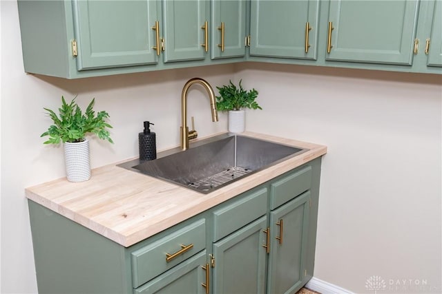 kitchen with sink and green cabinetry