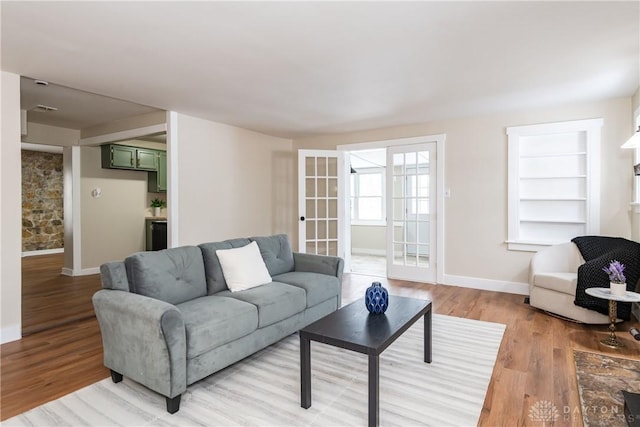 living room featuring light hardwood / wood-style floors and french doors