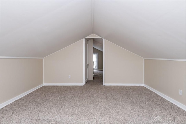 bonus room with lofted ceiling and carpet floors