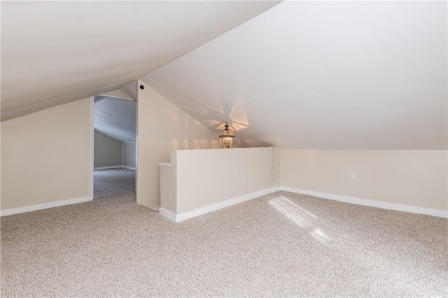 bonus room featuring vaulted ceiling and carpet