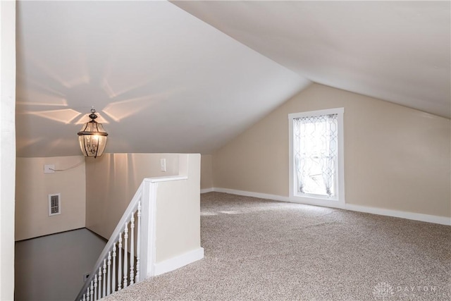 additional living space featuring lofted ceiling and carpet floors