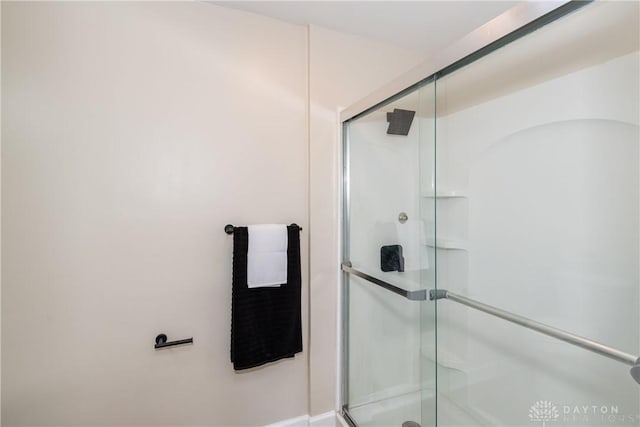 bathroom with a shower with door