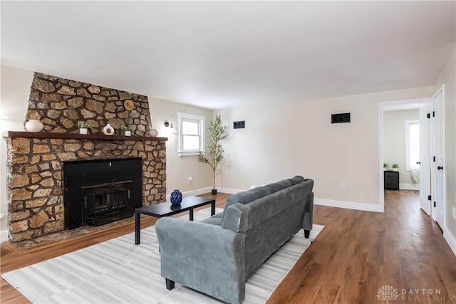 living room featuring a fireplace and wood-type flooring