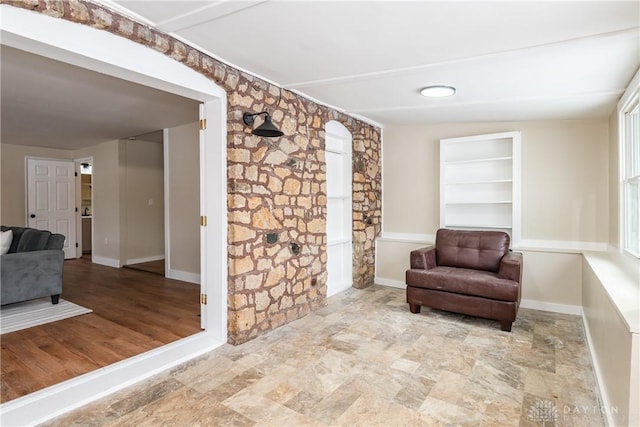 sitting room featuring vaulted ceiling