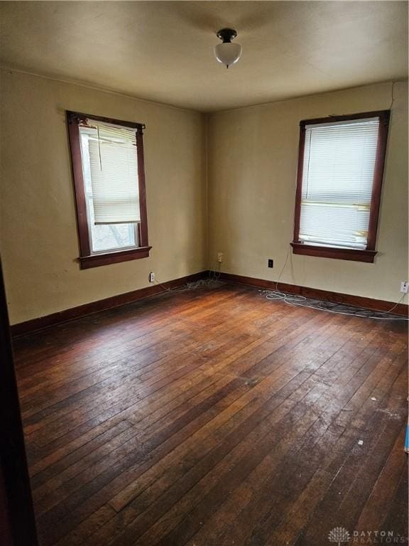 empty room with dark hardwood / wood-style floors