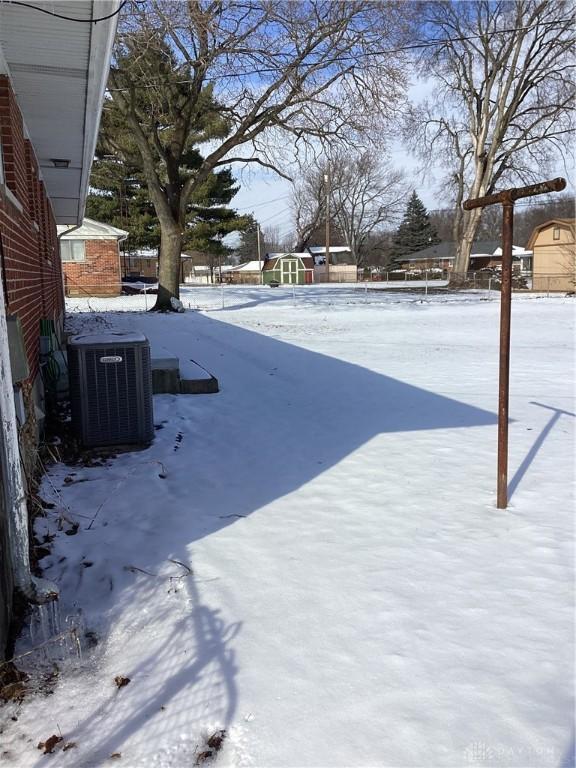 yard layered in snow featuring cooling unit