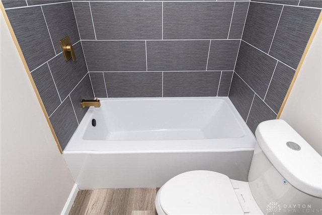 bathroom featuring shower / washtub combination and toilet