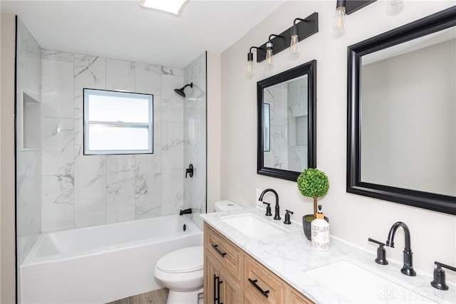 full bathroom with vanity, toilet, tiled shower / bath combo, and hardwood / wood-style flooring