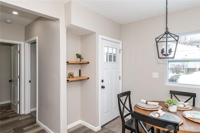 dining room featuring a chandelier and dark wood-type flooring