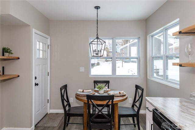 dining space featuring a chandelier and dark wood-type flooring