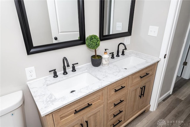 bathroom featuring vanity, toilet, and hardwood / wood-style floors