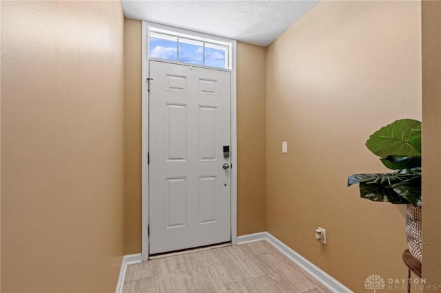 doorway featuring a textured ceiling