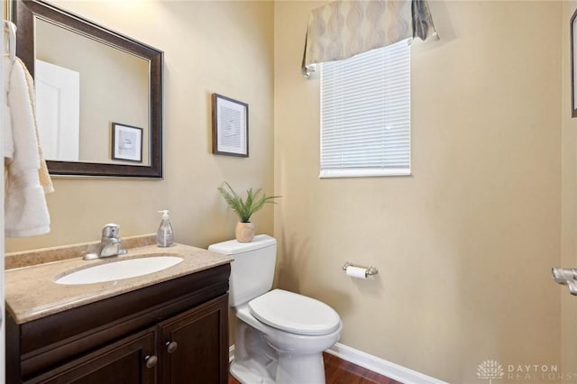 bathroom with vanity, wood-type flooring, and toilet