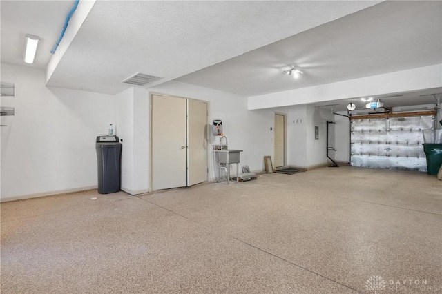 garage featuring sink and a garage door opener