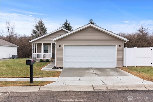 ranch-style house with a garage, a front yard, central AC unit, and covered porch