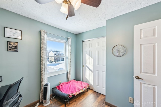 entrance foyer featuring ceiling fan, dark hardwood / wood-style floors, and a textured ceiling