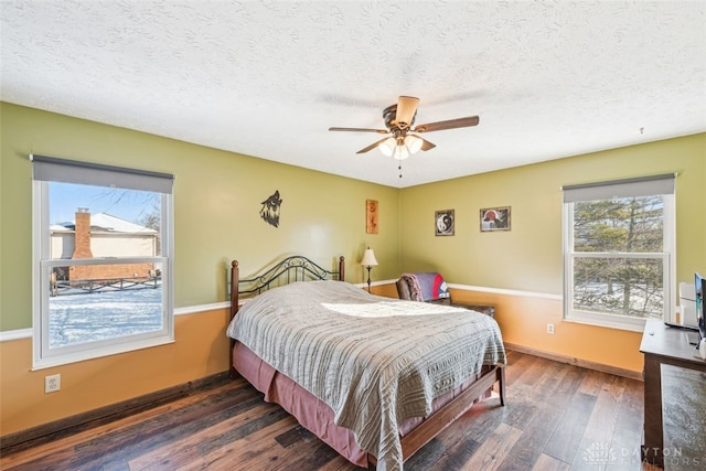 bedroom featuring a textured ceiling, dark wood-type flooring, and ceiling fan