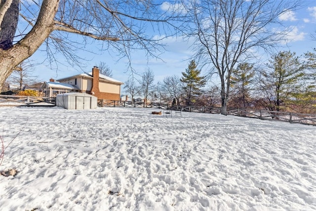 yard layered in snow with a shed