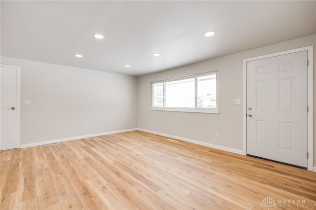 empty room with light hardwood / wood-style flooring