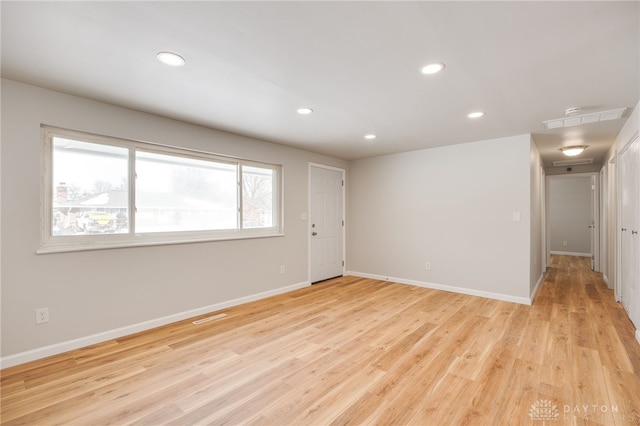 empty room with light hardwood / wood-style floors