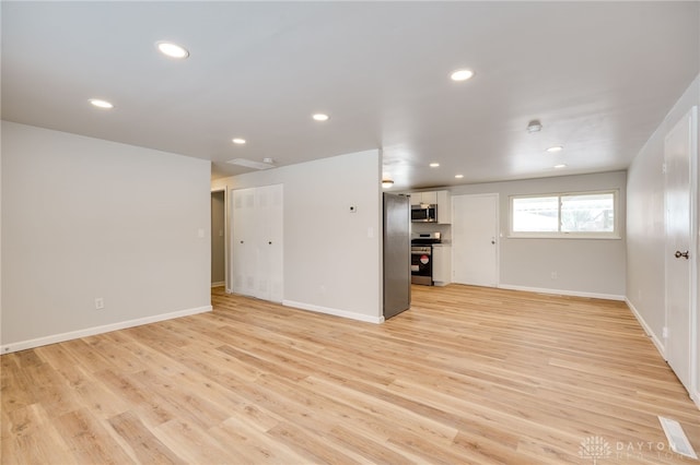 unfurnished living room with light hardwood / wood-style flooring