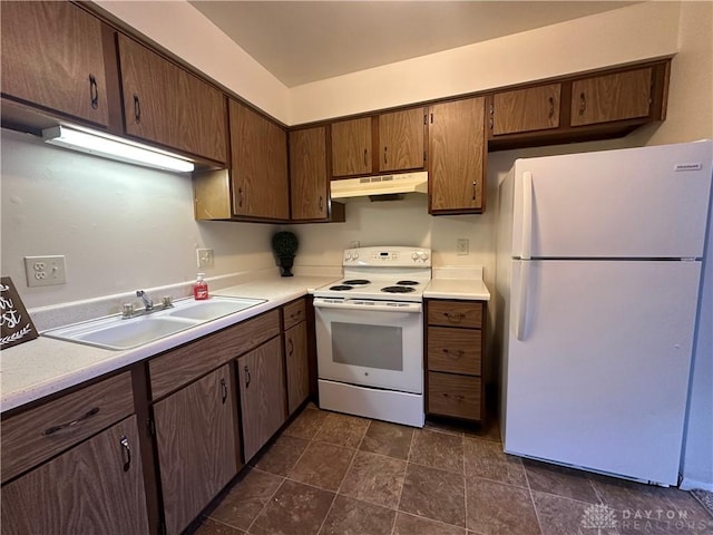 kitchen with sink, white appliances, and dark brown cabinets