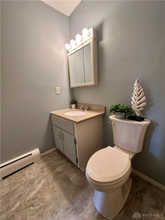 bathroom featuring vanity, toilet, and a baseboard heating unit