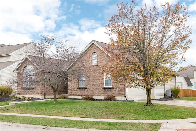 view of front of property with cooling unit, a front yard, and a garage