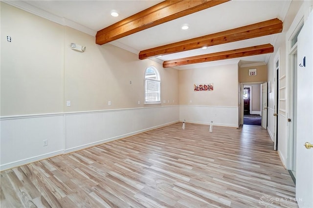 unfurnished room with light wood-type flooring, beamed ceiling, and ornamental molding