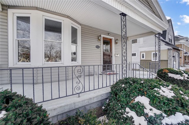 view of exterior entry featuring covered porch