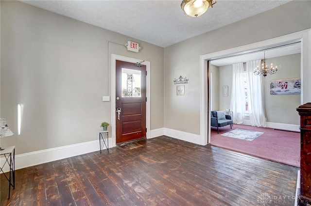 entryway with a textured ceiling and dark hardwood / wood-style flooring