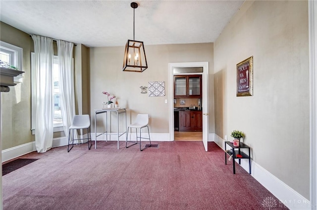 living area with plenty of natural light and carpet floors