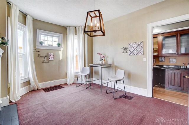 living area featuring a textured ceiling and light colored carpet