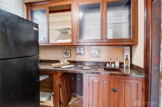 kitchen featuring sink and black fridge