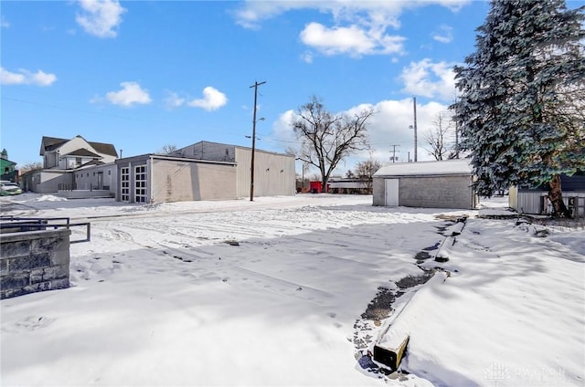 snowy yard with an outdoor structure