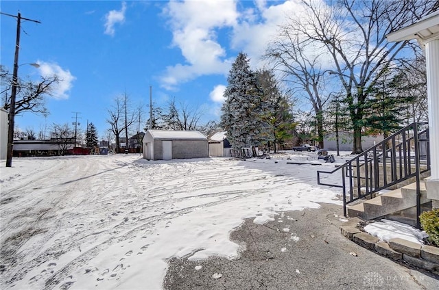 snowy yard with a storage unit