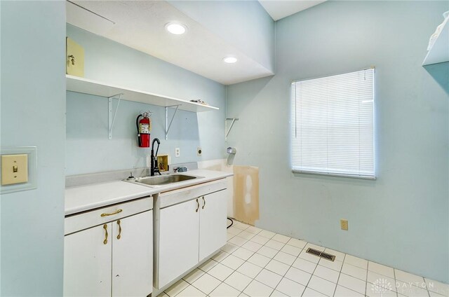 kitchen featuring sink, white cabinets, and light tile patterned floors