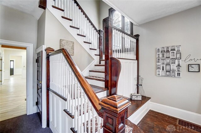 stairs featuring hardwood / wood-style floors