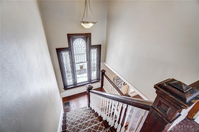 stairs featuring a towering ceiling